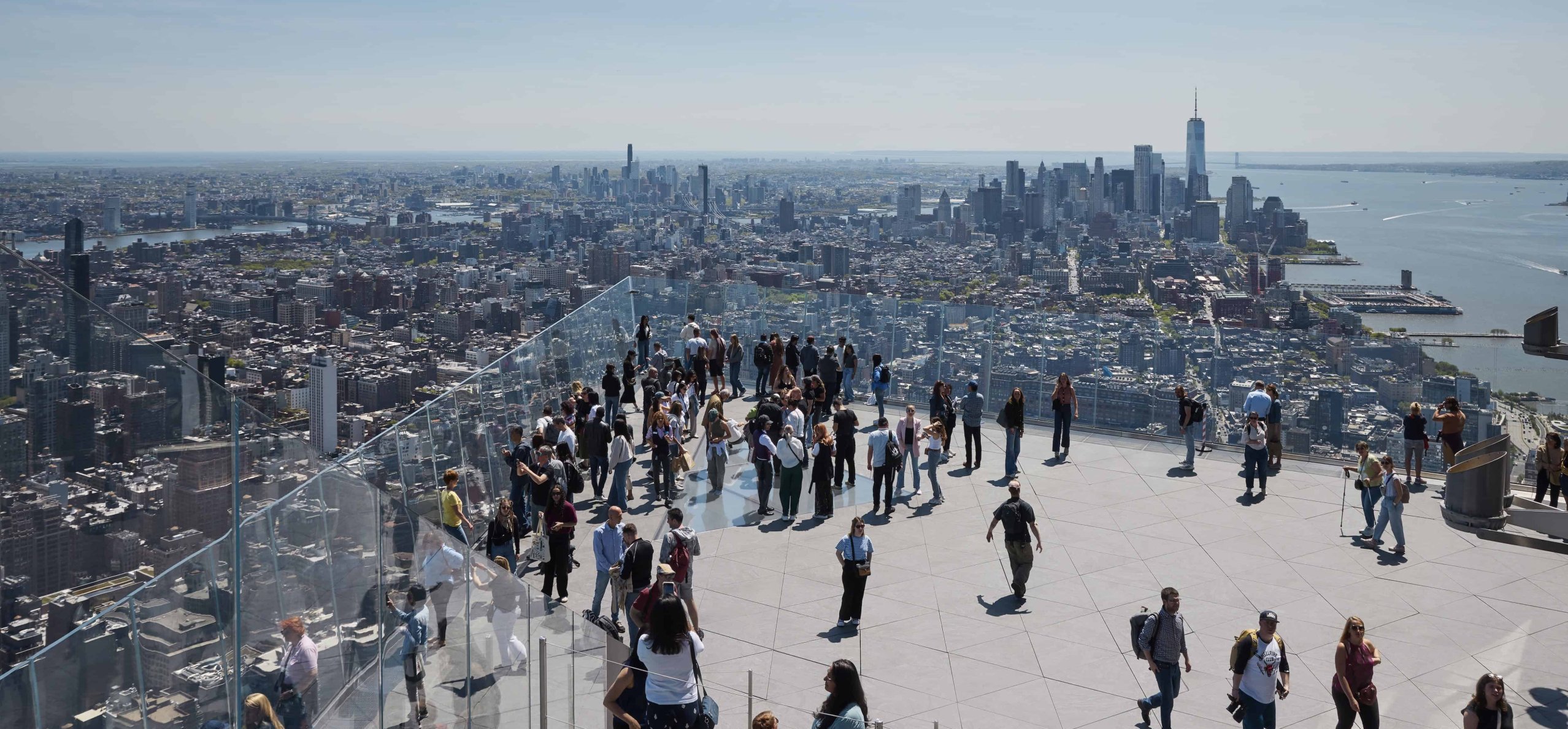 Visitors enjoy panoramic views from the outdoor sky deck at Edge NYC, Hudson Yards.