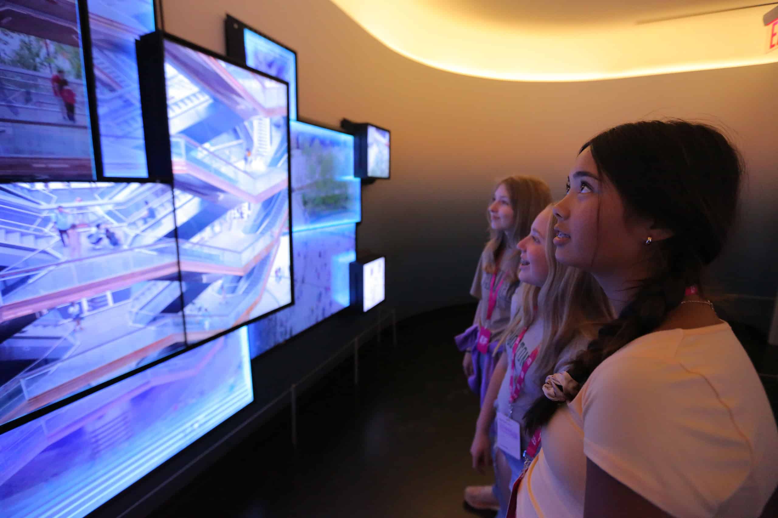 A group of students take in a display at The Edge
